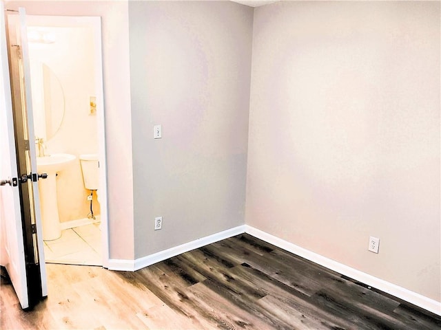 empty room with hardwood / wood-style flooring