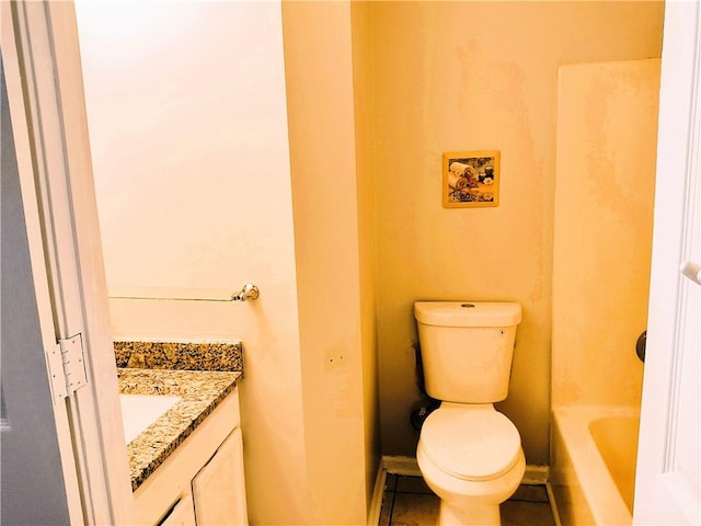 bathroom featuring tile patterned floors, vanity, a bath, and toilet