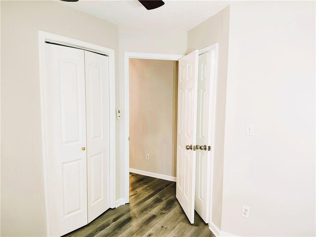 hallway featuring a textured ceiling and dark hardwood / wood-style flooring