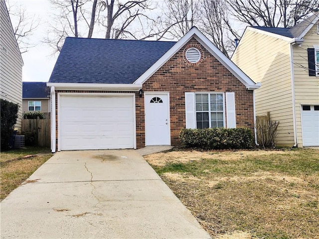 view of front of home with a garage and central AC