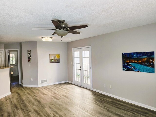 foyer featuring ceiling fan, dark wood-type flooring, and a textured ceiling