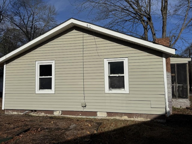 view of side of property featuring a sunroom