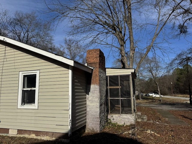 view of side of home with a sunroom