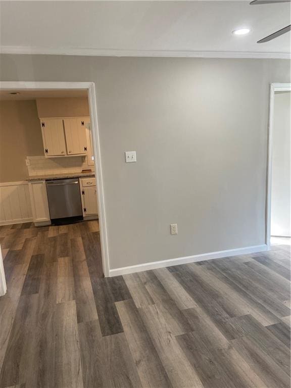 interior space with ornamental molding, ceiling fan, baseboards, and dark wood-style floors