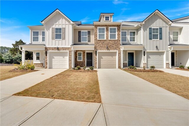 105 Village Green Dr Unit 171, Adairsville, GA 30103 - townhome / multi-family property with stone siding, board and batten siding, concrete driveway, and a garage