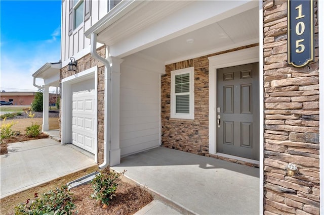 105 Village Green Dr Unit 171, Adairsville, GA 30103 - property entrance with stone siding, concrete driveway, and a garage