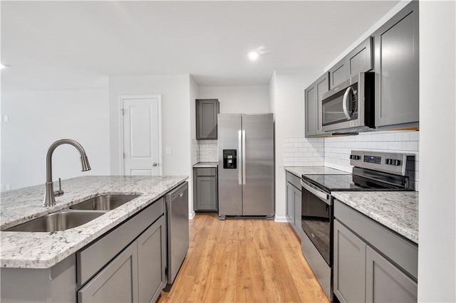 105 Village Green Dr Unit 171, Adairsville, GA 30103 - kitchen featuring light wood finished floors, a sink, gray cabinets, and appliances with stainless steel finishes