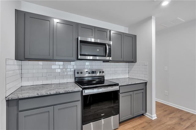 105 Village Green Dr Unit 171, Adairsville, GA 30103 - kitchen featuring light wood finished floors, visible vents, gray cabinets, and appliances with stainless steel finishes