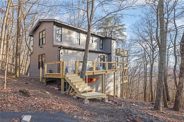 rear view of property with a wooden deck