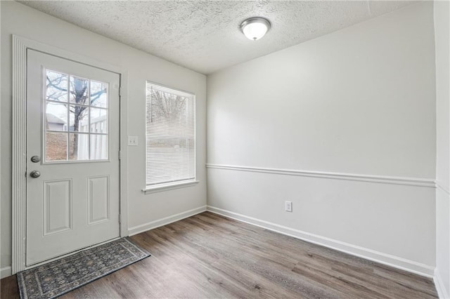 4282 Worth St NW, Acworth, GA 30101 - doorway featuring baseboards, wood finished floors, and a textured ceiling