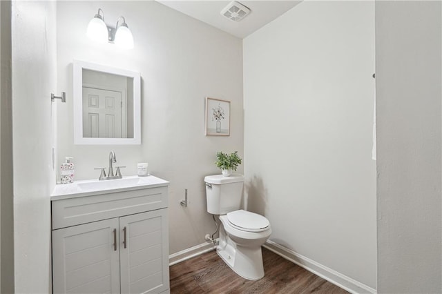 4282 Worth St NW, Acworth, GA 30101 - half bath with toilet, baseboards, visible vents, wood finished floors, and vanity