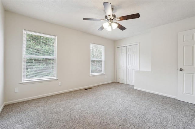 4282 Worth St NW, Acworth, GA 30101 - unfurnished bedroom featuring visible vents, a ceiling fan, a closet, baseboards, and carpet flooring