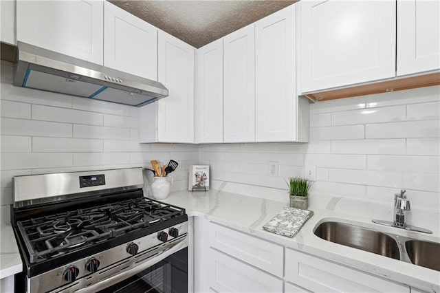 4282 Worth St NW, Acworth, GA 30101 - kitchen with white cabinets, stainless steel range with gas cooktop, under cabinet range hood, and a sink