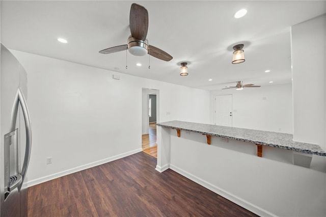 unfurnished room with ceiling fan and dark hardwood / wood-style flooring