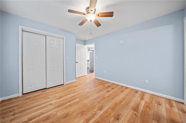 unfurnished bedroom featuring light hardwood / wood-style flooring, a closet, and ceiling fan