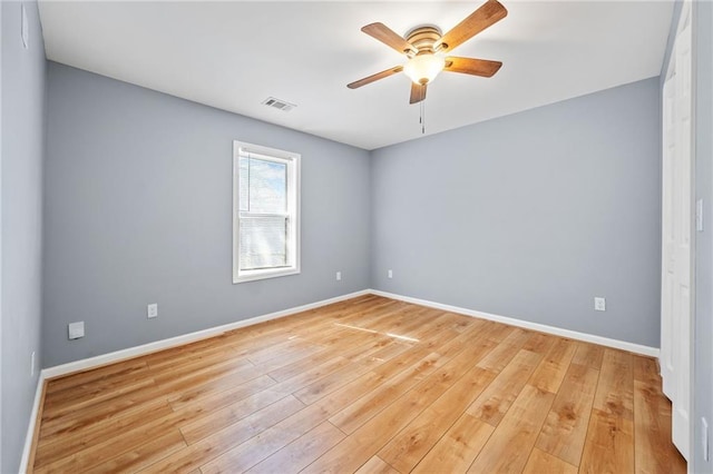 spare room featuring ceiling fan and light wood-type flooring