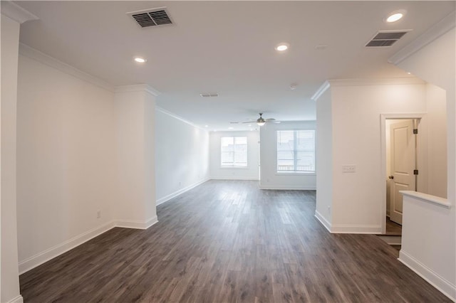 empty room with crown molding, ceiling fan, and dark hardwood / wood-style flooring