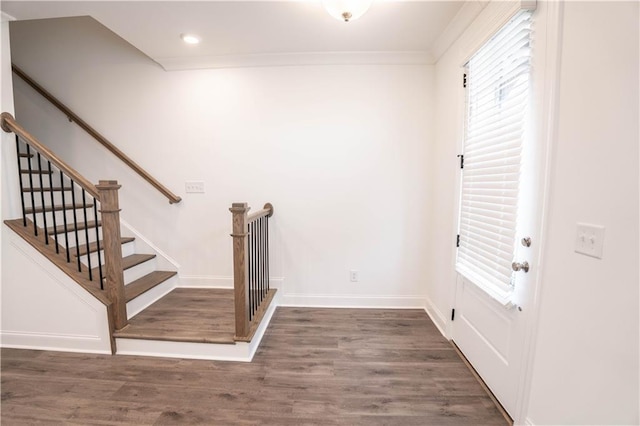 stairs with hardwood / wood-style flooring and ornamental molding