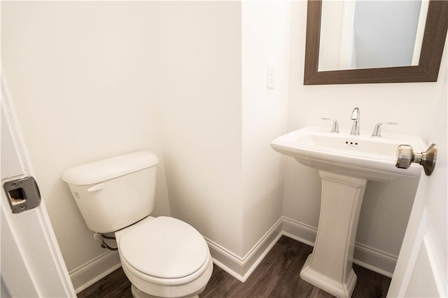 bathroom with sink, toilet, and hardwood / wood-style floors