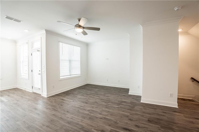 unfurnished room featuring plenty of natural light, ornamental molding, dark hardwood / wood-style floors, and ceiling fan