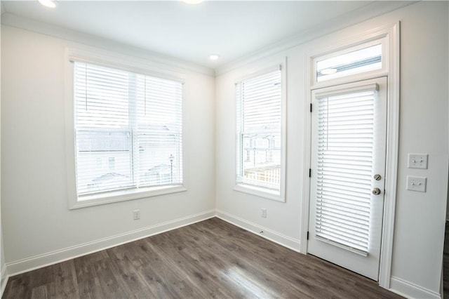 unfurnished room with crown molding and dark hardwood / wood-style flooring