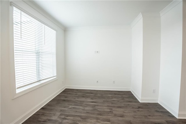 empty room featuring dark hardwood / wood-style flooring, crown molding, and a healthy amount of sunlight