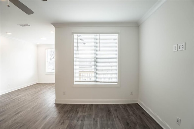 unfurnished room with crown molding, plenty of natural light, dark wood-type flooring, and ceiling fan