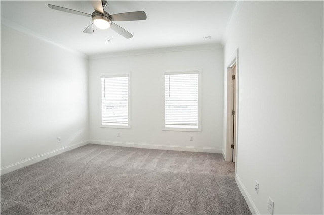 carpeted spare room with crown molding and ceiling fan