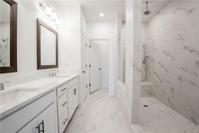 bathroom with vanity and a tile shower