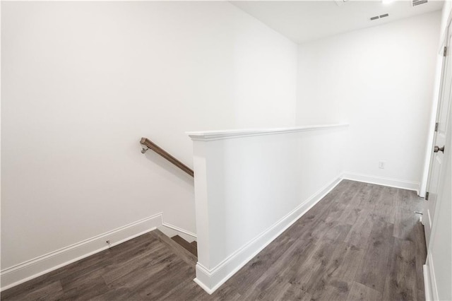 hallway with hardwood / wood-style floors