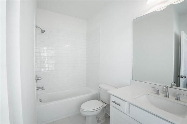 full bathroom featuring tiled shower / bath combo, vanity, and toilet