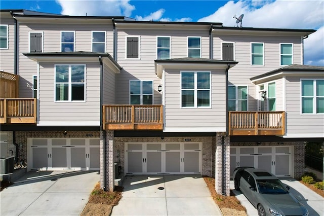 rear view of property featuring a garage and a balcony