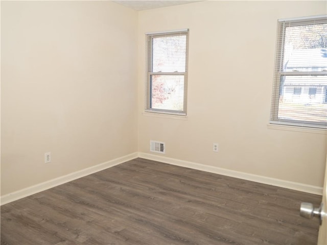 empty room featuring dark hardwood / wood-style floors