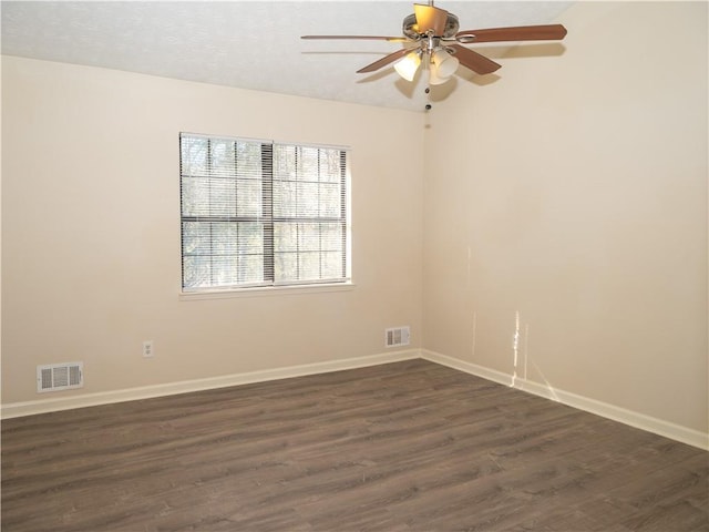 empty room featuring ceiling fan and dark hardwood / wood-style floors