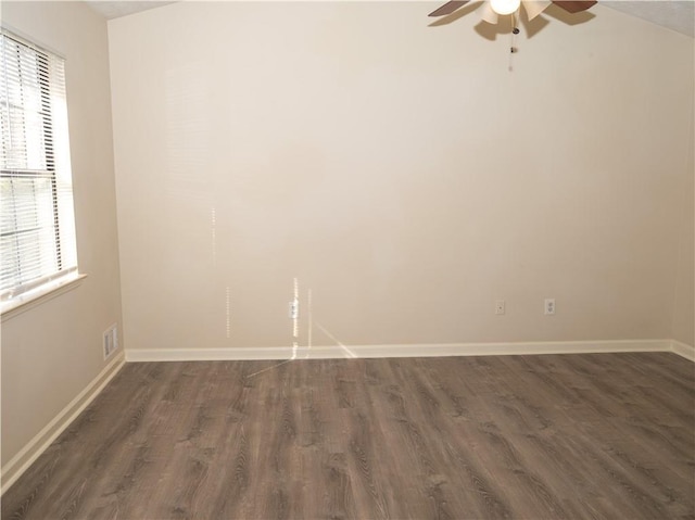 empty room with ceiling fan, dark wood-type flooring, and lofted ceiling