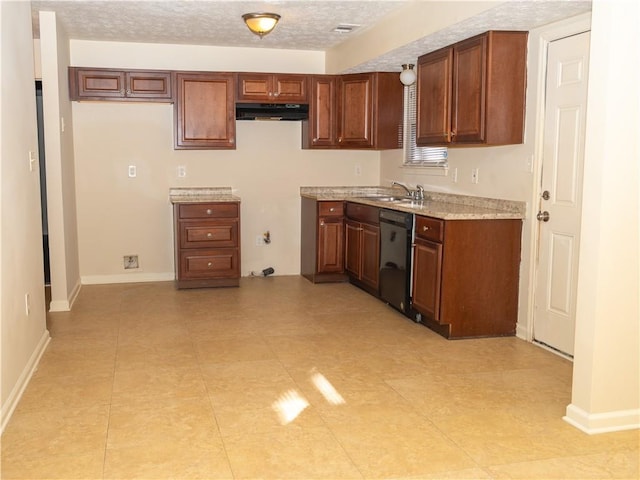 kitchen featuring dishwasher, light tile patterned flooring, sink, and a textured ceiling