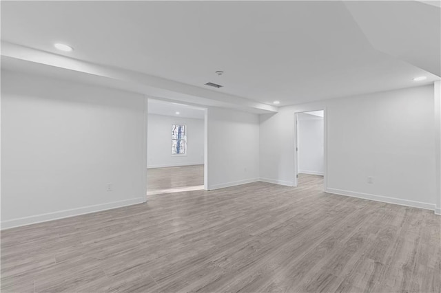 below grade area featuring visible vents, recessed lighting, baseboards, and light wood finished floors