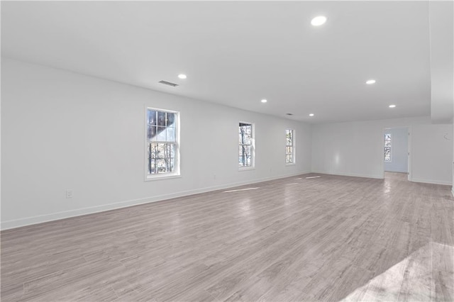 unfurnished room featuring recessed lighting, visible vents, light wood finished floors, and baseboards