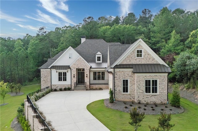 11 Brownson Ct, Acworth, GA 30101 - view of front of property with a standing seam roof, a front lawn, a chimney, and brick siding