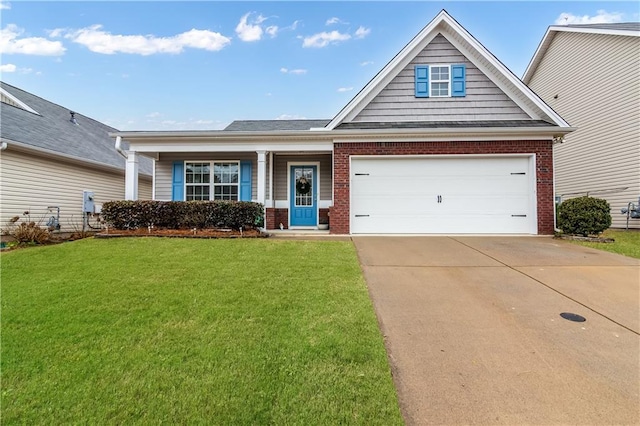 view of front of property featuring driveway, a garage, a front lawn, and brick siding