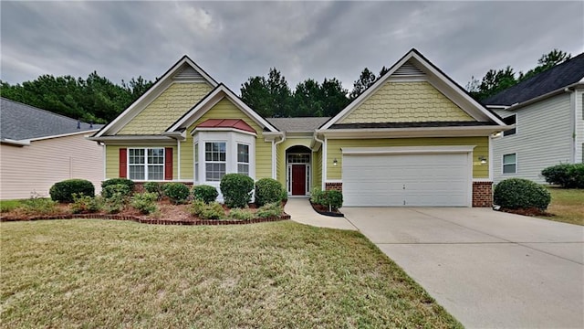 craftsman-style house featuring a front yard and a garage