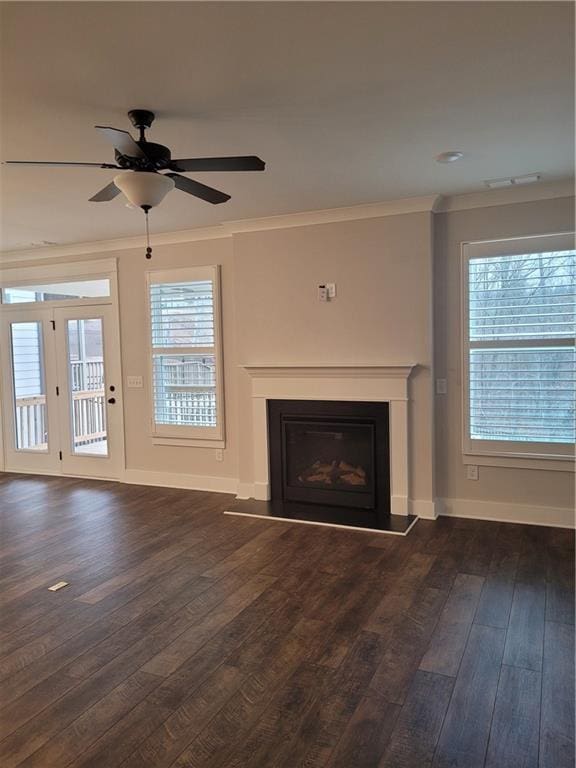 unfurnished living room with dark hardwood / wood-style floors, ceiling fan, and crown molding