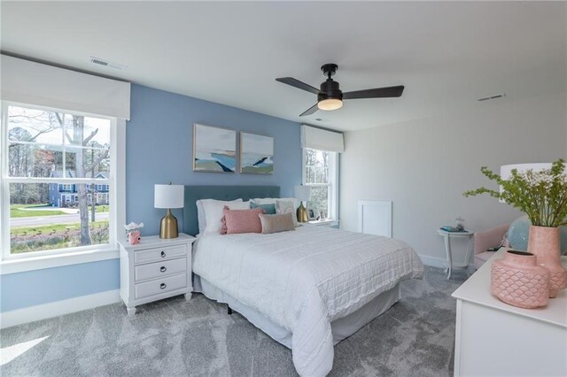 bedroom featuring ceiling fan and carpet