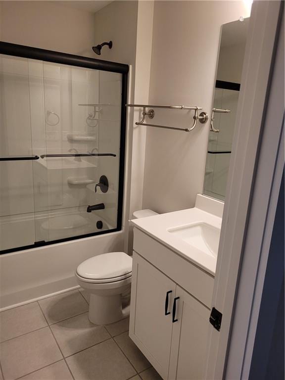 full bathroom featuring tile patterned flooring, vanity, enclosed tub / shower combo, and toilet