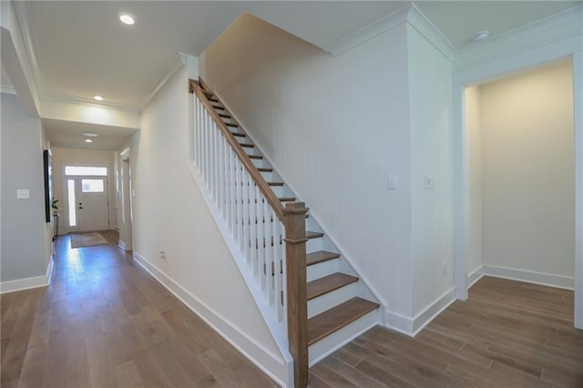 stairway featuring hardwood / wood-style flooring and ornamental molding