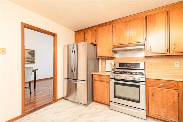 4065 Maxanne Dr NW, Kennesaw, GA 30144 - kitchen with light countertops, appliances with stainless steel finishes, marble finish floor, and under cabinet range hood