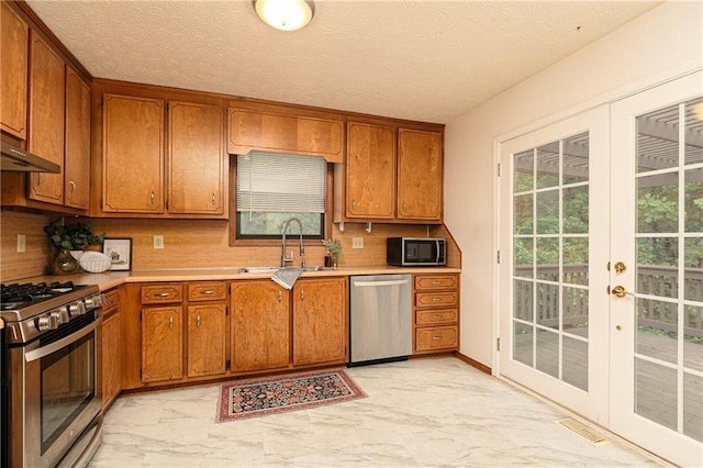 4065 Maxanne Dr NW, Kennesaw, GA 30144 - kitchen with brown cabinetry, marble finish floor, stainless steel appliances, and a sink