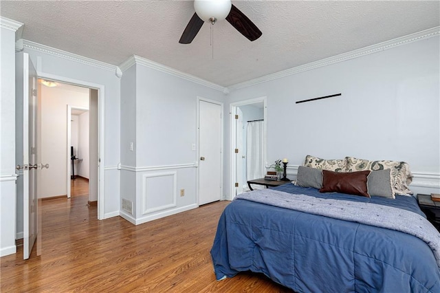 4065 Maxanne Dr NW, Kennesaw, GA 30144 - bedroom with light wood-style floors, ceiling fan, a textured ceiling, and ornamental molding