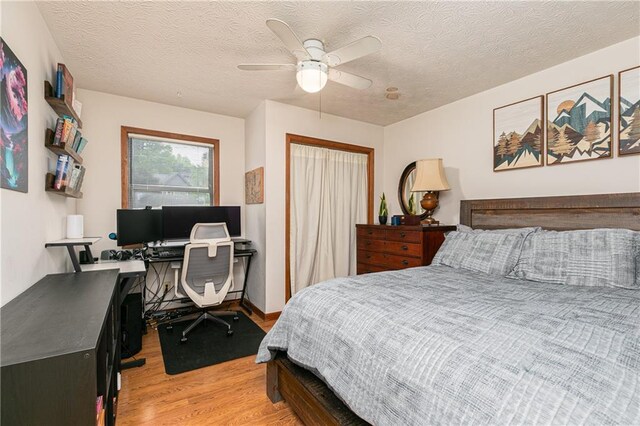 4065 Maxanne Dr NW, Kennesaw, GA 30144 - bedroom with a textured ceiling, light wood-type flooring, a closet, and a ceiling fan