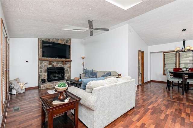 4065 Maxanne Dr NW, Kennesaw, GA 30144 - living area with dark wood finished floors, visible vents, baseboards, ceiling fan with notable chandelier, and a fireplace